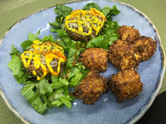 this is a plate with open faced hamburgers and delicata squash hush puppies