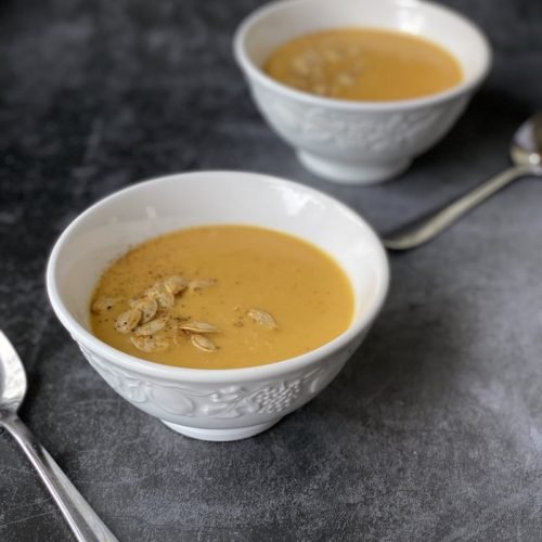 this is a photo of pumpkin bisque with toasted pumpkin seeds