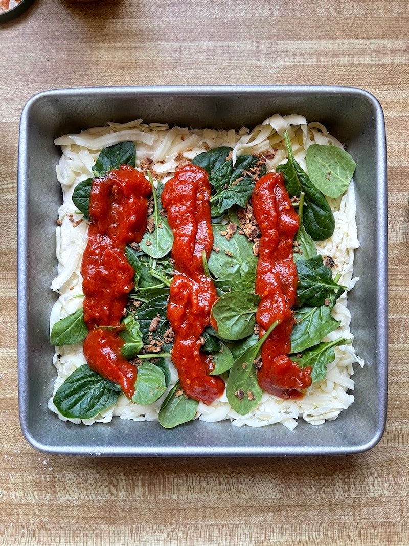 this is a photo of detroit style pizza ready for the oven