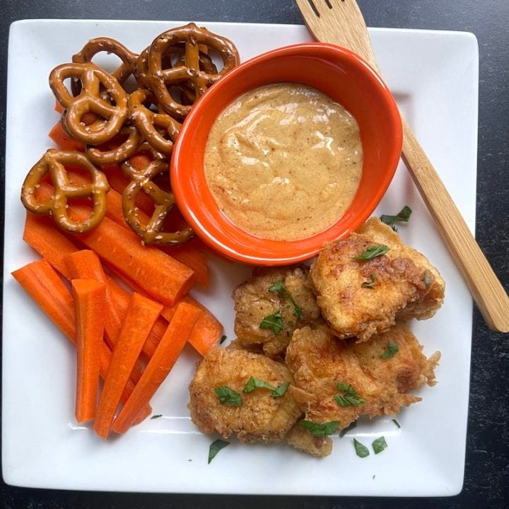 This is a photo of a copycat Raising Cane's Sauce Recipe with chicken nuggets