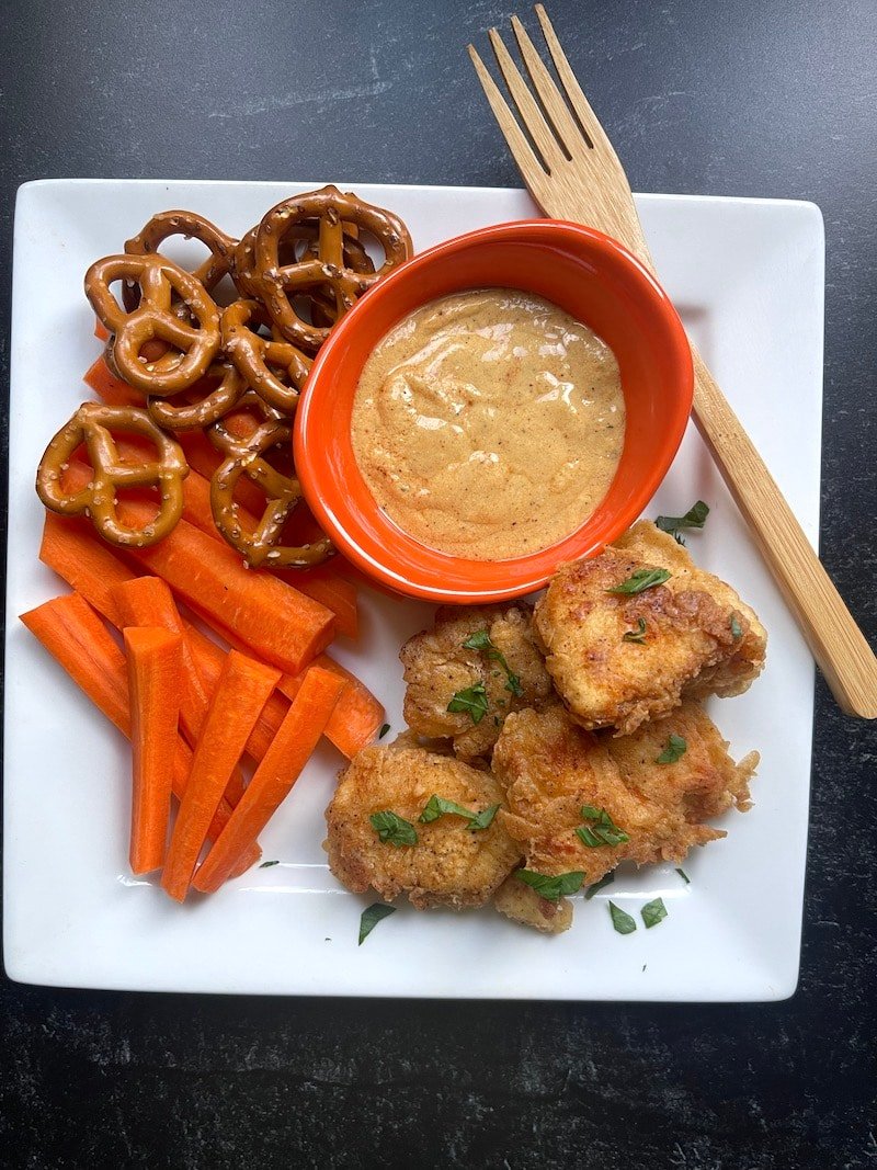 This is a photo of a copycat Raising Cane's Sauce Recipe with chicken nuggets