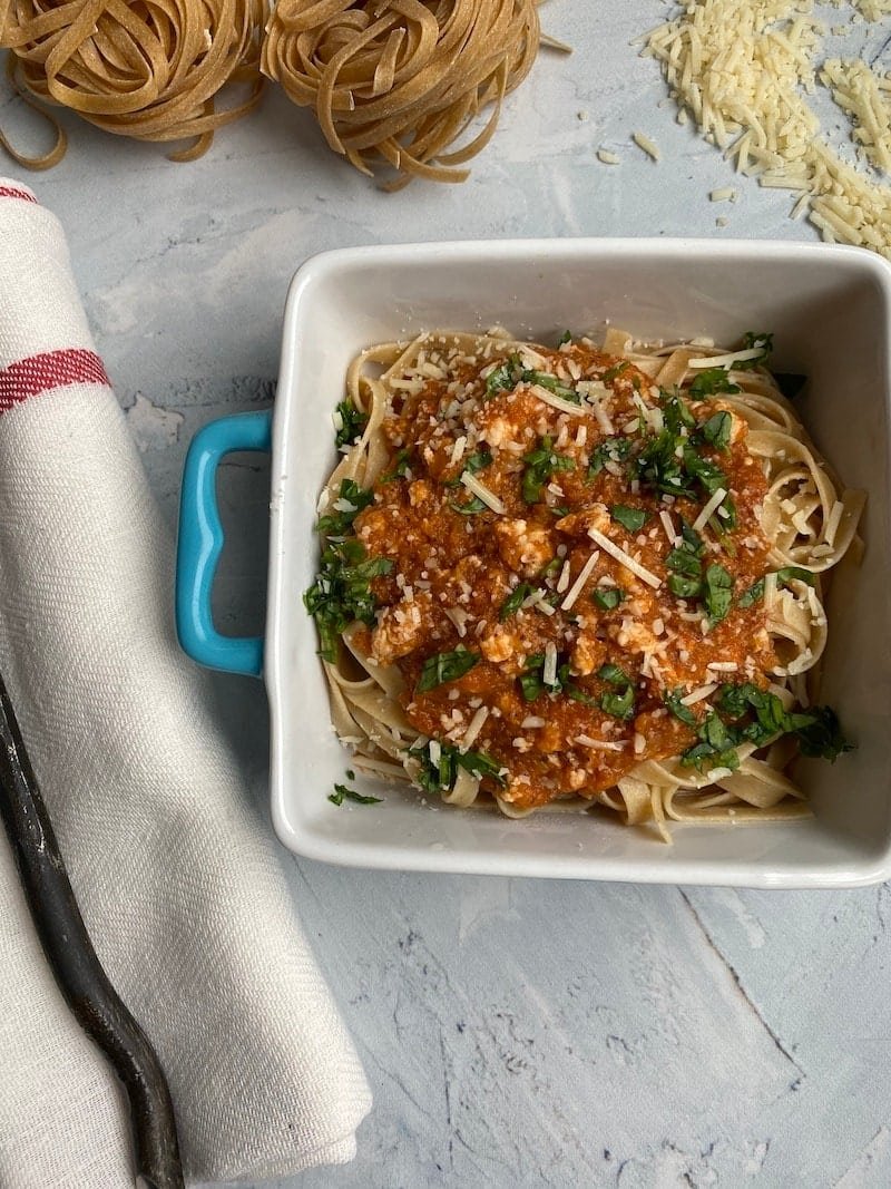 this is a bowl of pasta with chicken bolognese