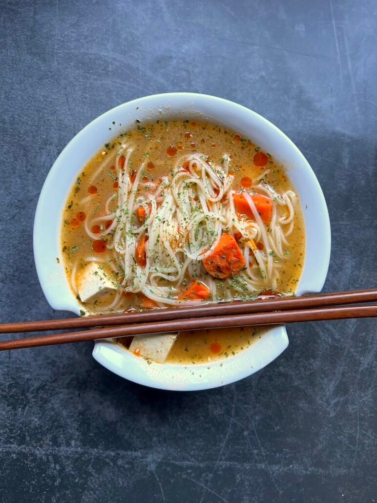 this is a bowl of white miso soup with tofu