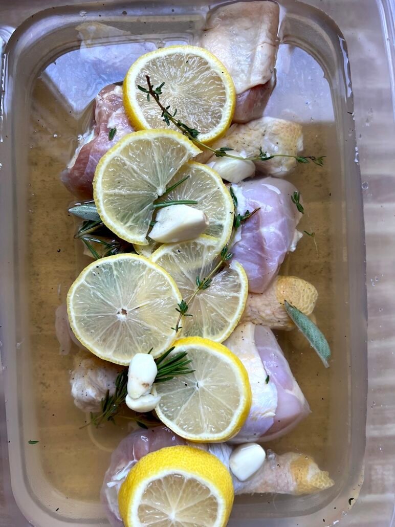 This is a container of chicken being brined with a salt mixture