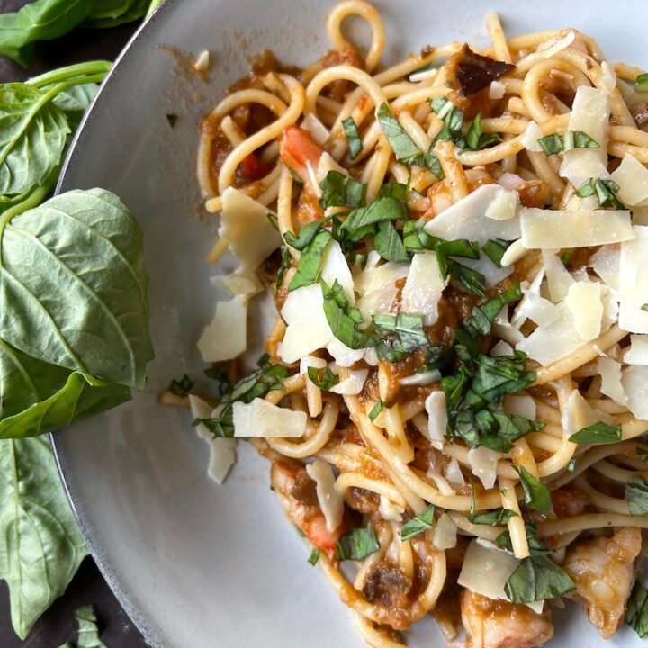 this is a plate of eggplant spread shrimp pasta