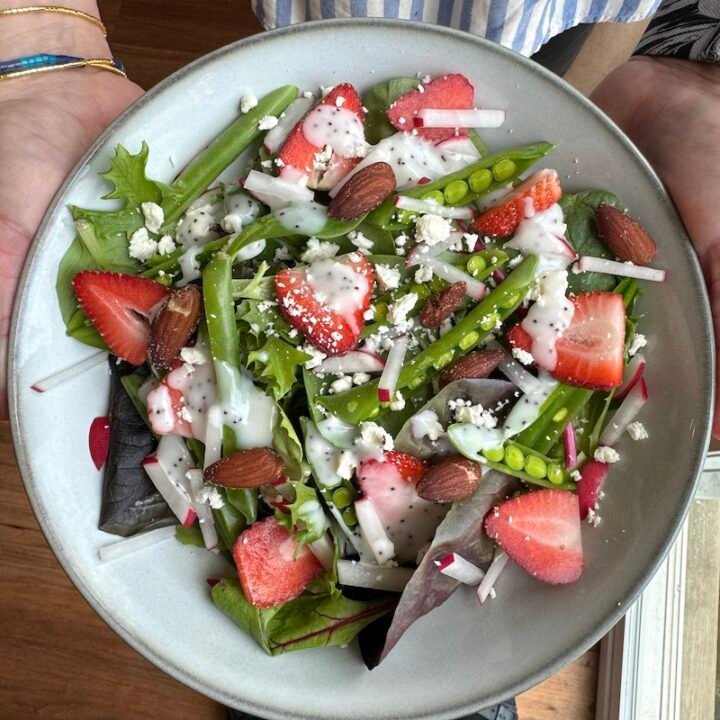 this is a bowl containing ingredients for a spring salad