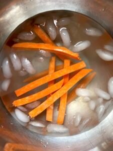 these are sweet potatoes that are soaking in an ice bath