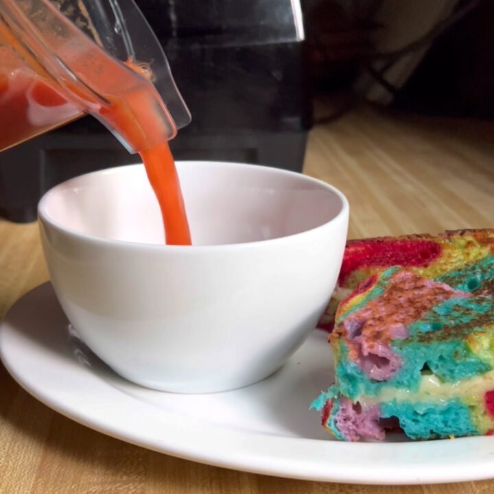 this is blender tomato soup being poured into a bowl