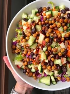 this is a vegan salad with mixed greens, crispy chickpeas and oil and vinegar dressing