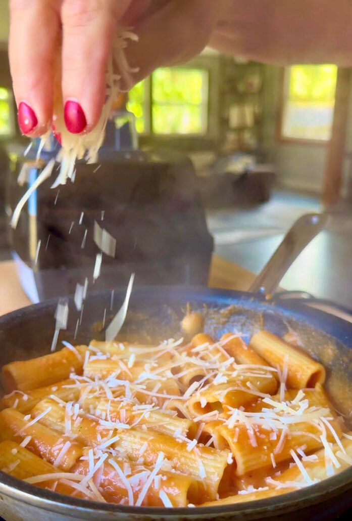 delicata squash being sprinkled with parmesan cheese