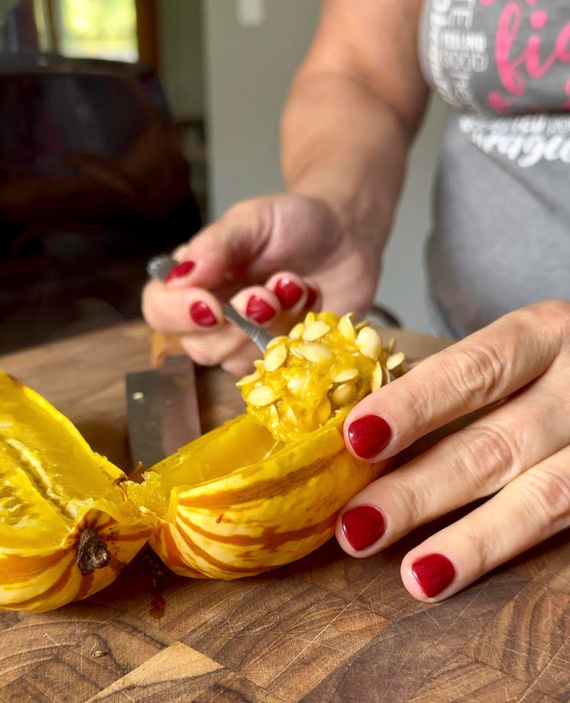 this is a delicata squash sliced and removing seeds