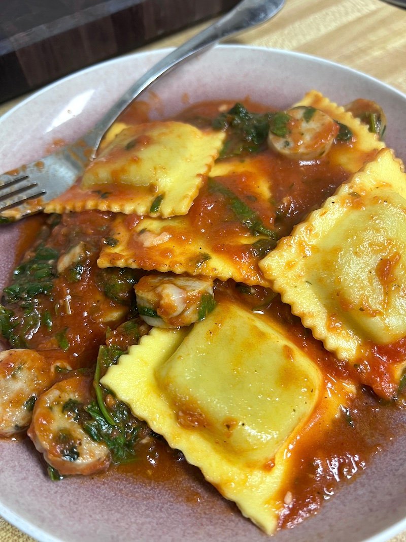 This is Hungry Root meal of Kite Hill ravioli with chicken sausage and marinara